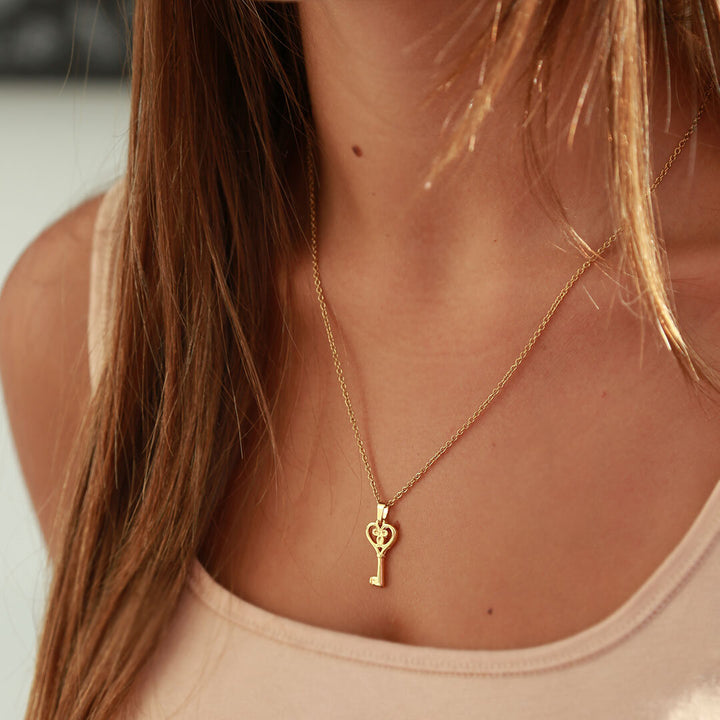 Gold necklace heart key